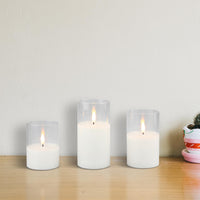 Stonebriar 3-pack real-wax flameless LED pillar candles in clear glass hurricanes, with remote and timer