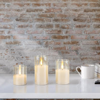 Stonebriar 3-pack real-wax flameless LED pillar candles in gold glass hurricanes, with remote and timer