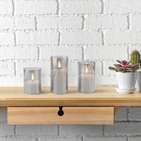 Stonebriar 3-pack real-wax flameless LED pillar candles in glass hurricanes, with remote and timer