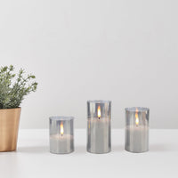Stonebriar 3-pack real-wax flameless LED pillar candles in glass hurricanes, with remote and timer